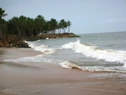 Kerala beach at sunset with a wooden fishing boat